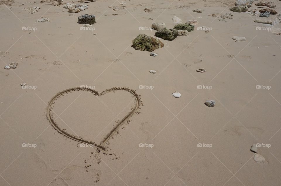 Love in the sand. Beach sand with heart drawing