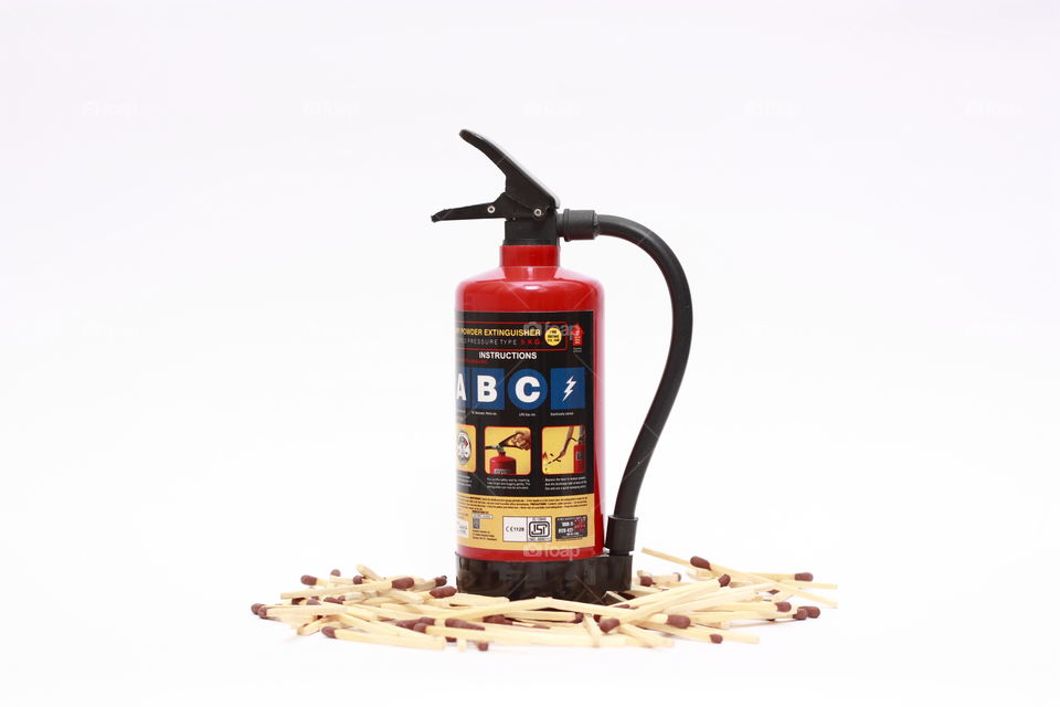 an extinguisher surrounded by match sticks