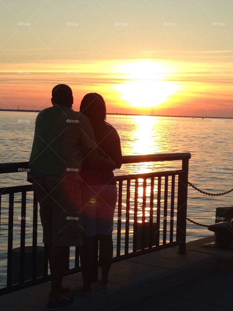 Silhouette of couple deck during sunset