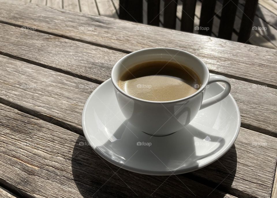 A cup of coffee on wooden table