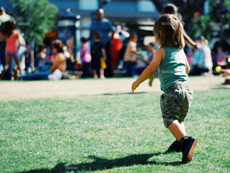 kid running to his mom at city park 