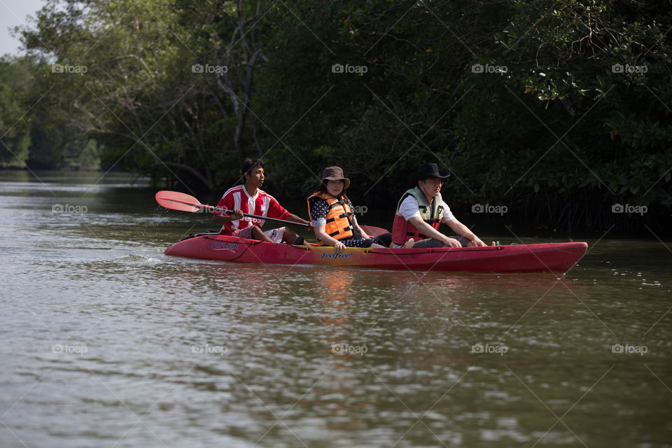 Tourist sitting in the canoe boat in the river