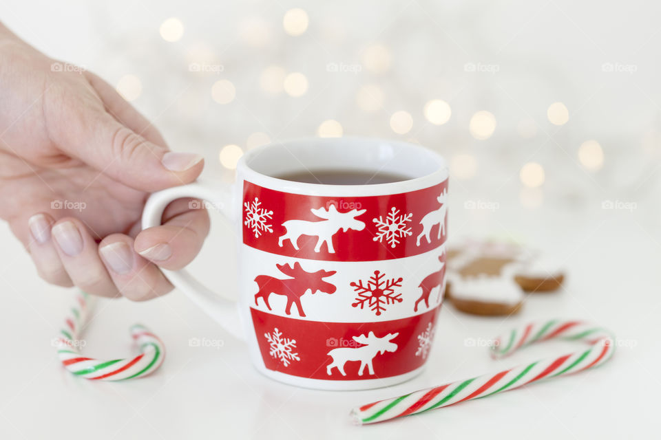 Cup of aromatic tea in the hand