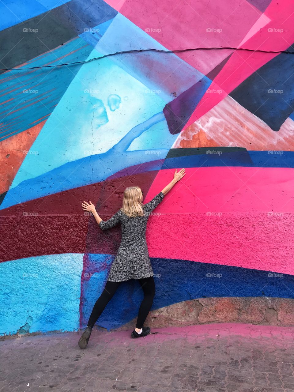 Posing in front of colorful wall