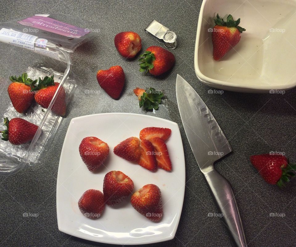 Preparation hulling and slicing the best strawberries in the world. English strawberries. 