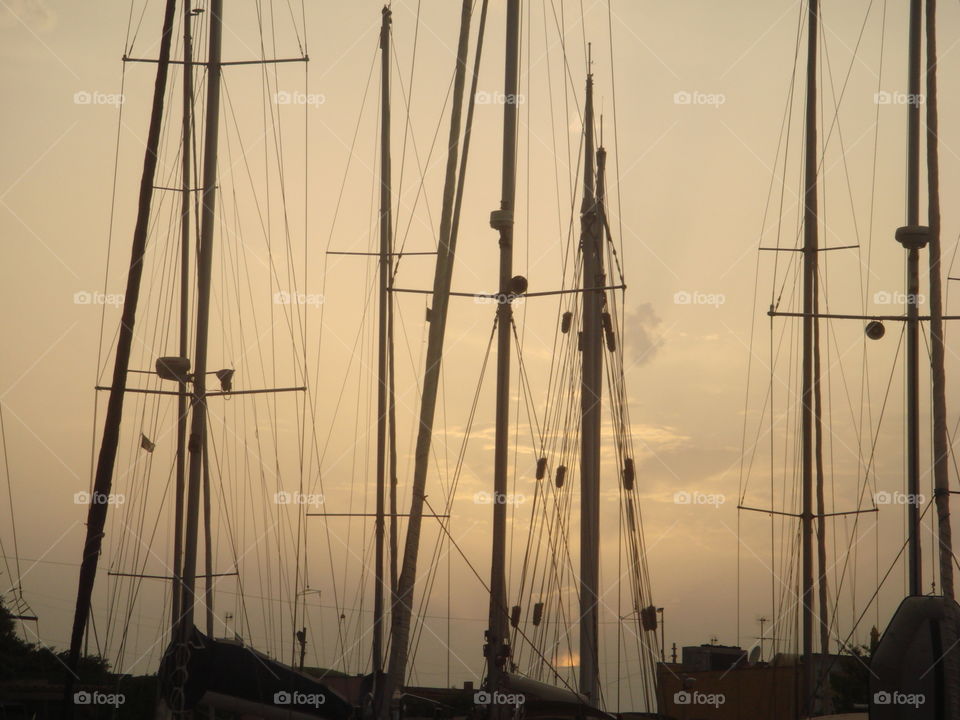 sails of boat at sunset