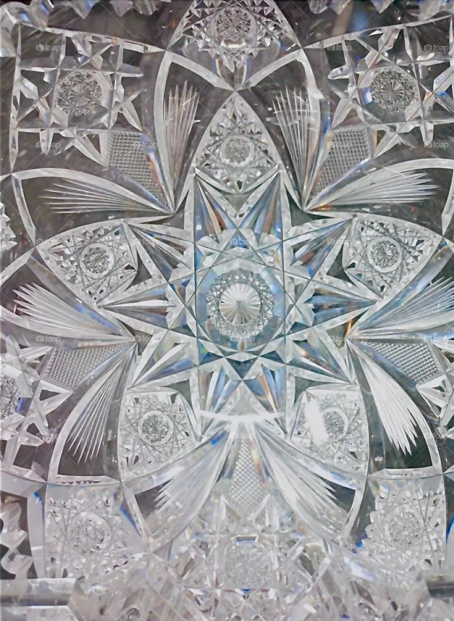 This is a closeup of the inside of a crystal glass bowl with a really exquisite pattern of interwoven geometric shapes. 2023. Hypnotic Productions