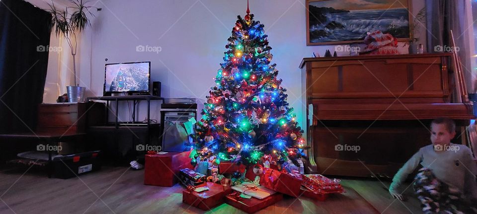 Presents underneath Christmas tree. Holidays joy and excitement.