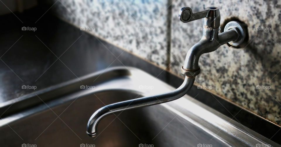 water faucet in the sink in the kitchen in an apartment or house