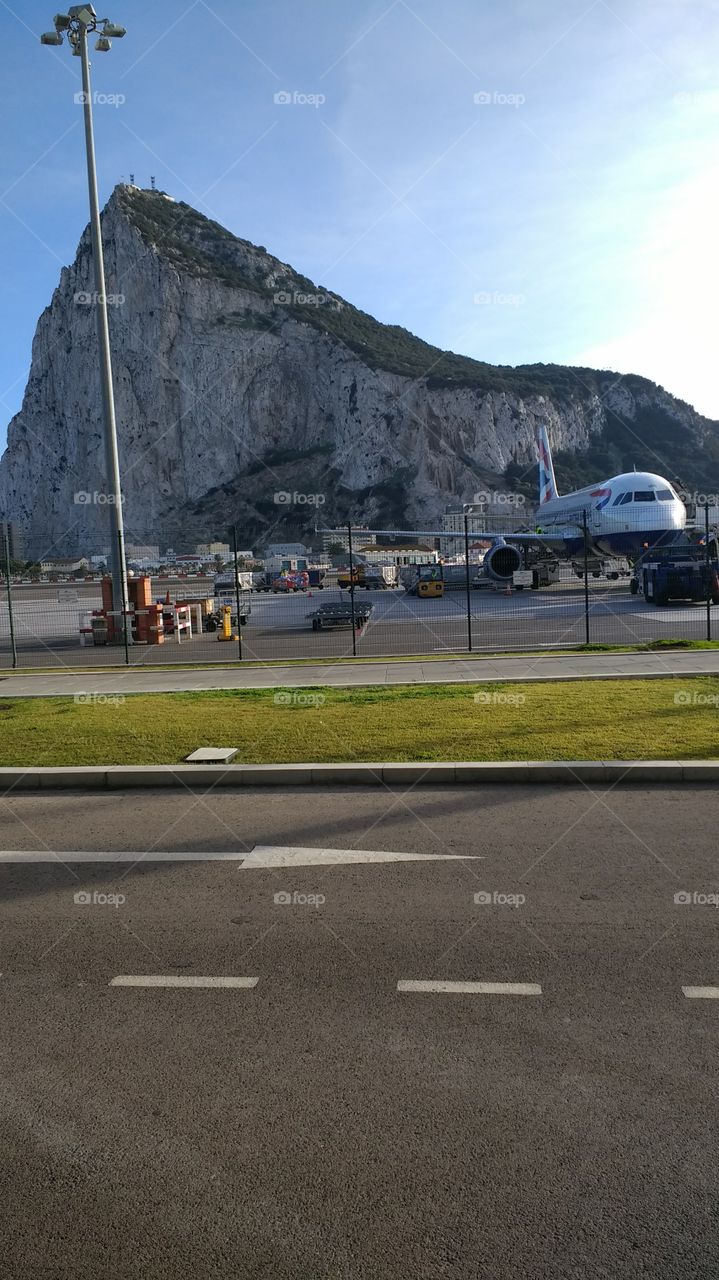 plane landing in Gibraltar airport under the Rock of Gibraltar