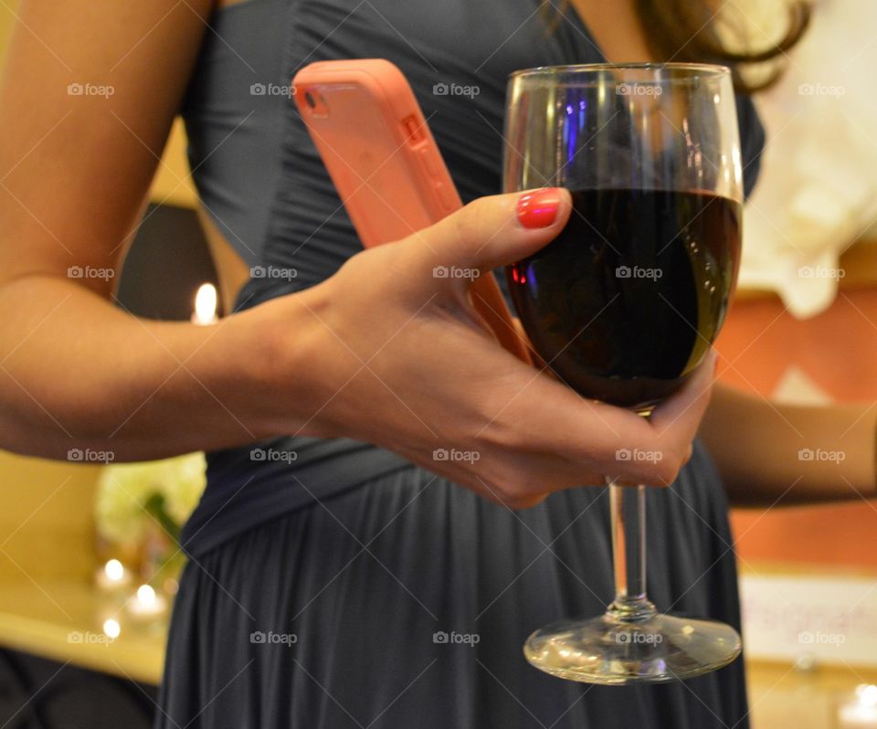 Lady in Evening Gown Holding a Glass of Red Wine at a Party