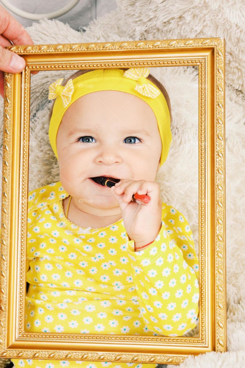 Baby in yellow dress. Baby in yellow dress inside frame