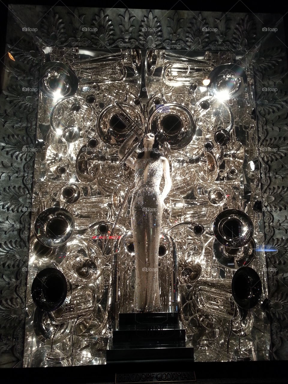 Chrome. Beautiful mannequin surrounded by chromed trumpets