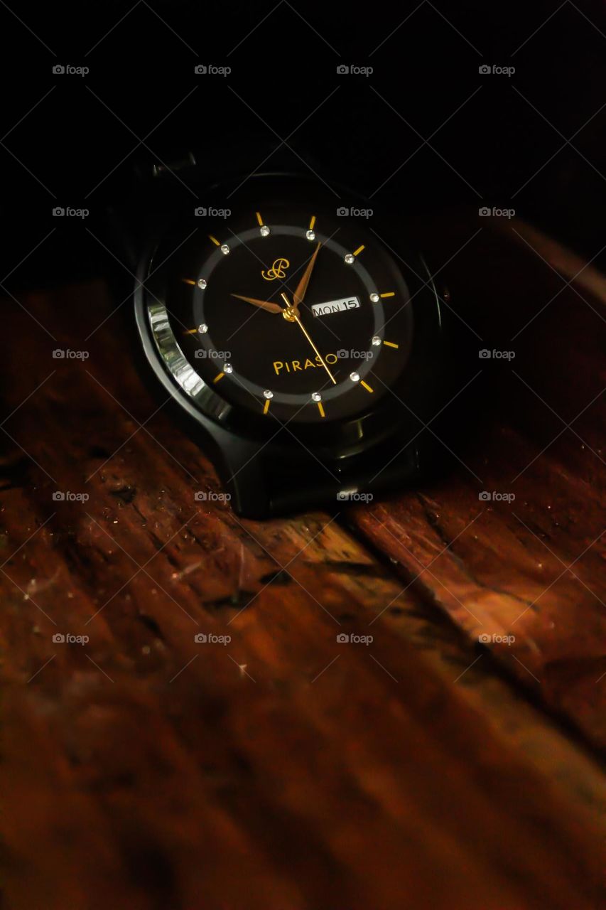 black Dial wrist watch on bood background