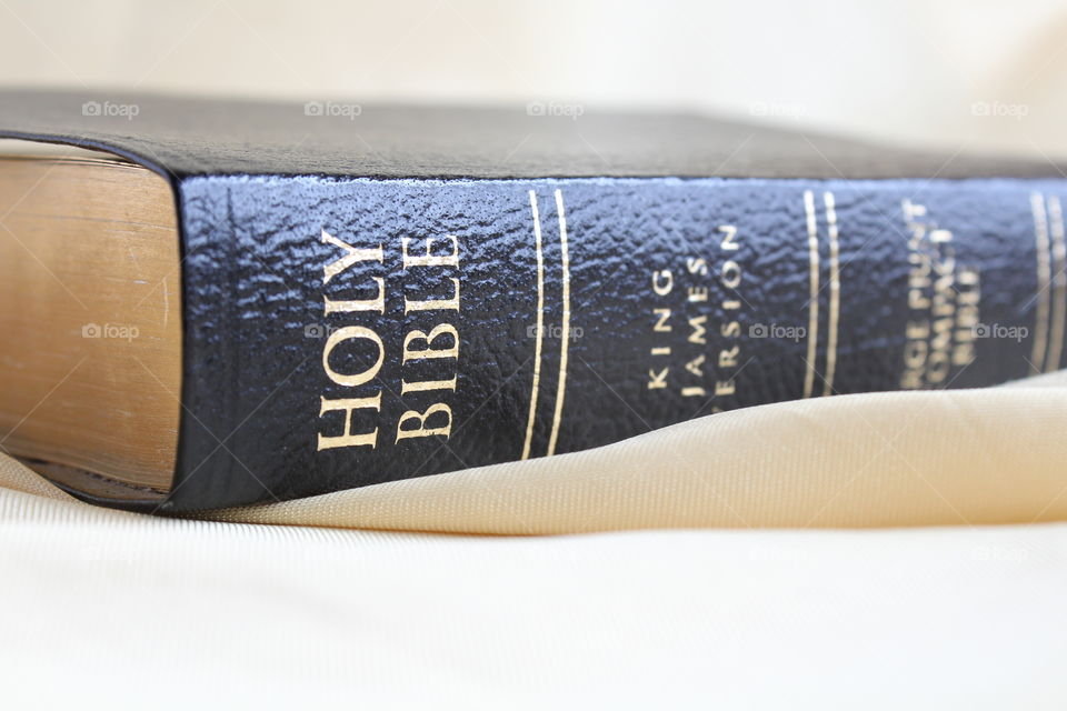 Holy Bible on gold textile material