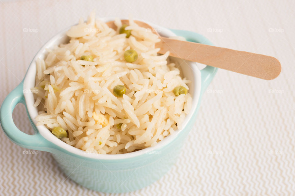 Egg fried rice in blue bowl. Egg fried rice in blue bowl with a wooden spoon