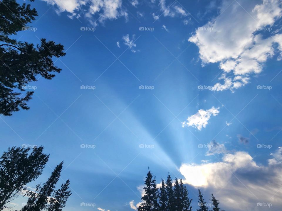 Sunshine coming through the fluffy white clouds