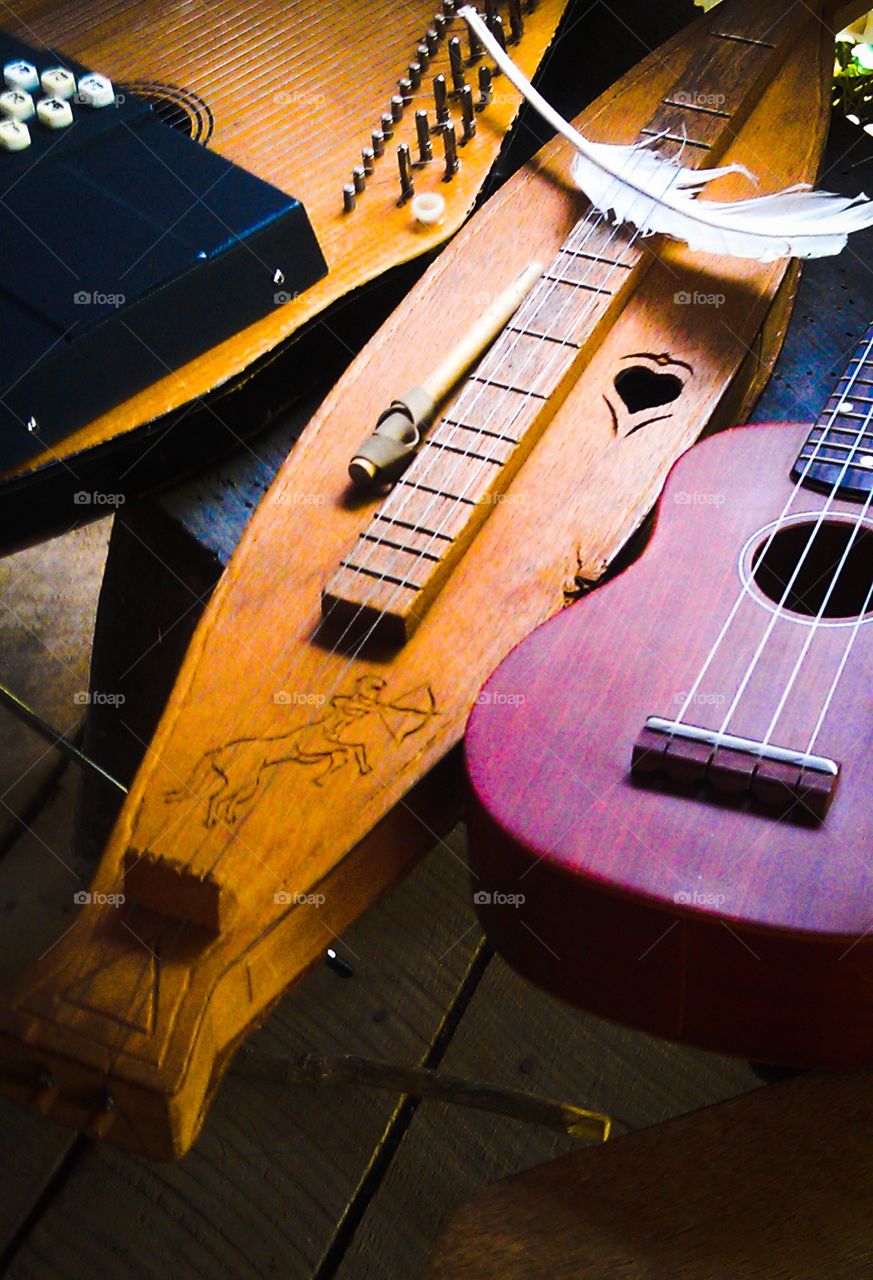 Instruments of the Past. Wood crafted instruments & feather