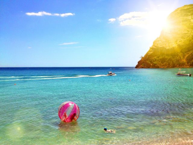 Tourist inside the large pink ball floating on sea