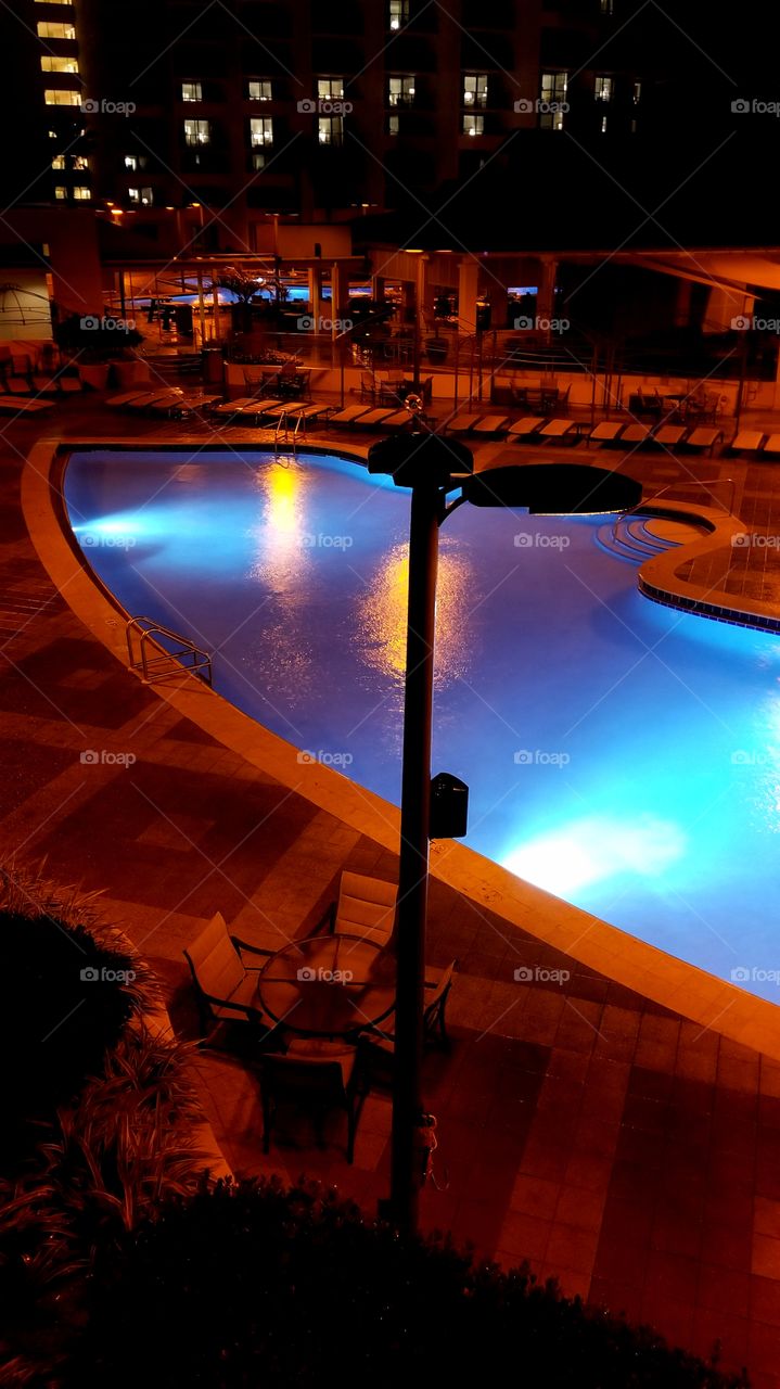 view of the beautiful pool at midnight and the resort.