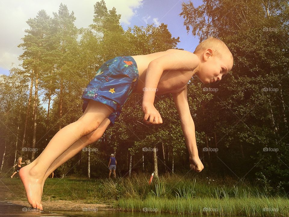 Diving. A boy diving during the golden hour