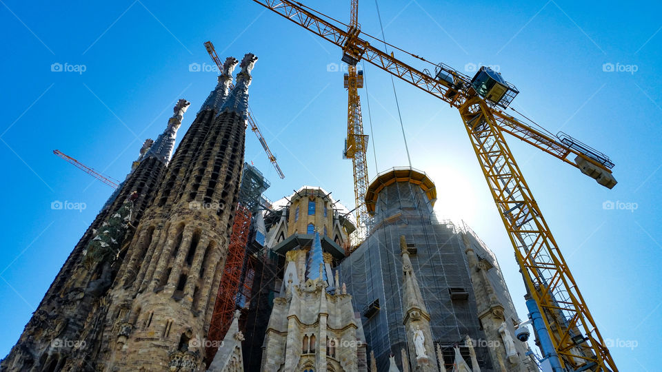 church and cranes in the city and a beautiful blue sky