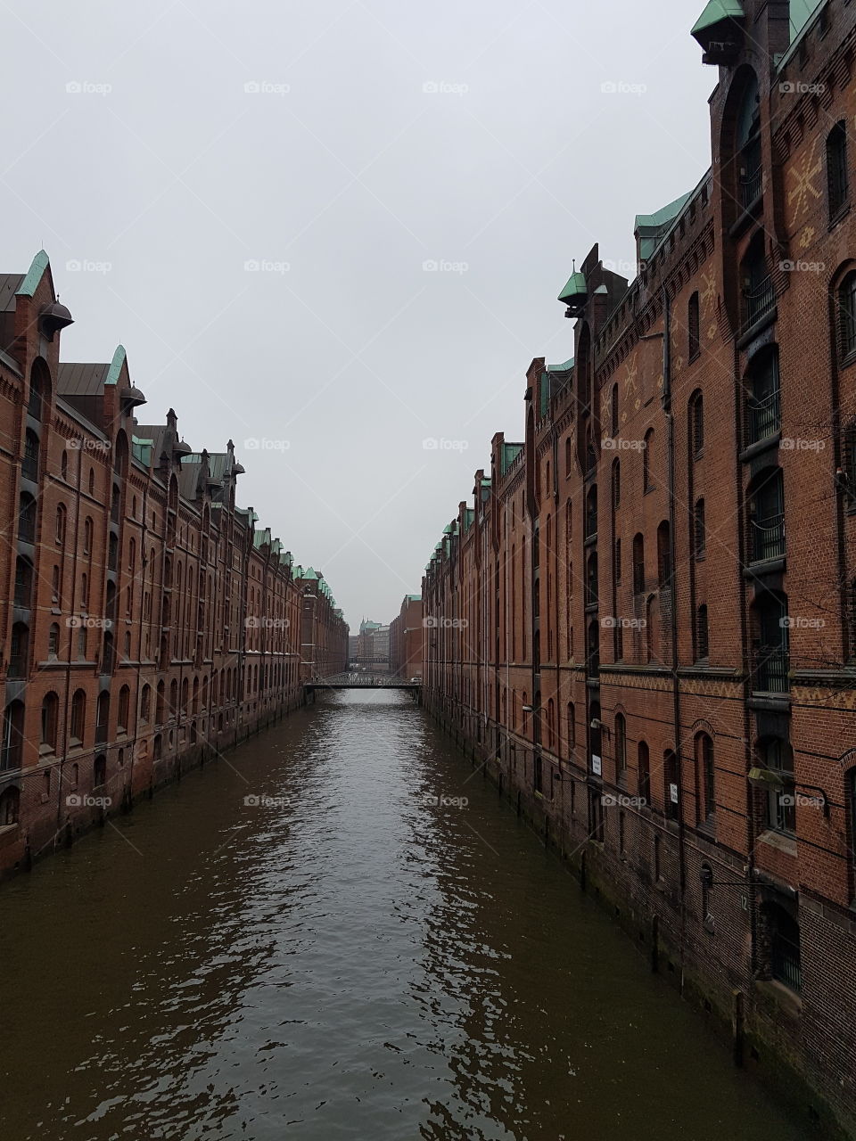 Old docks separated with a canal in Hafencity. Hamburg. Germany.