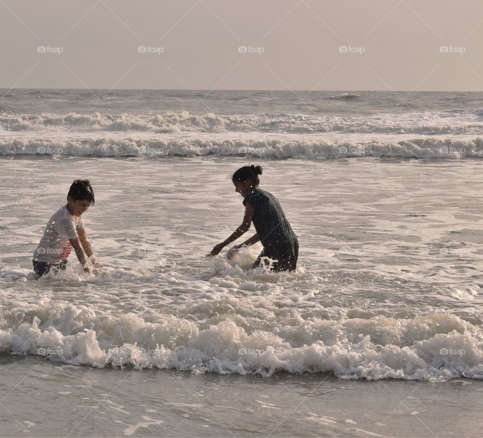 fun time with splashing water on the beach in summer