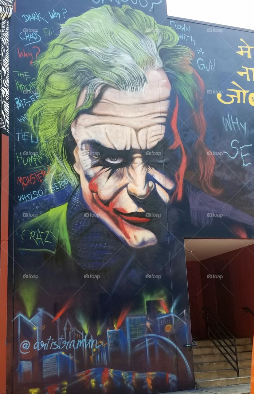 Heath Ledger as joker graffiti artwork on building exit.