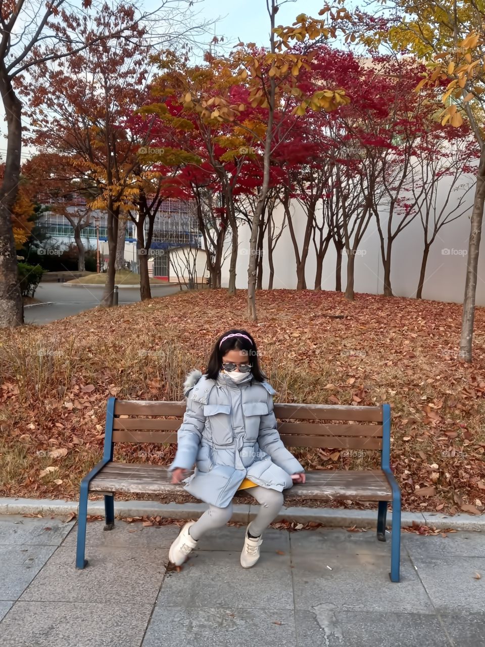 A girl sit on the chair outside after the long walked.