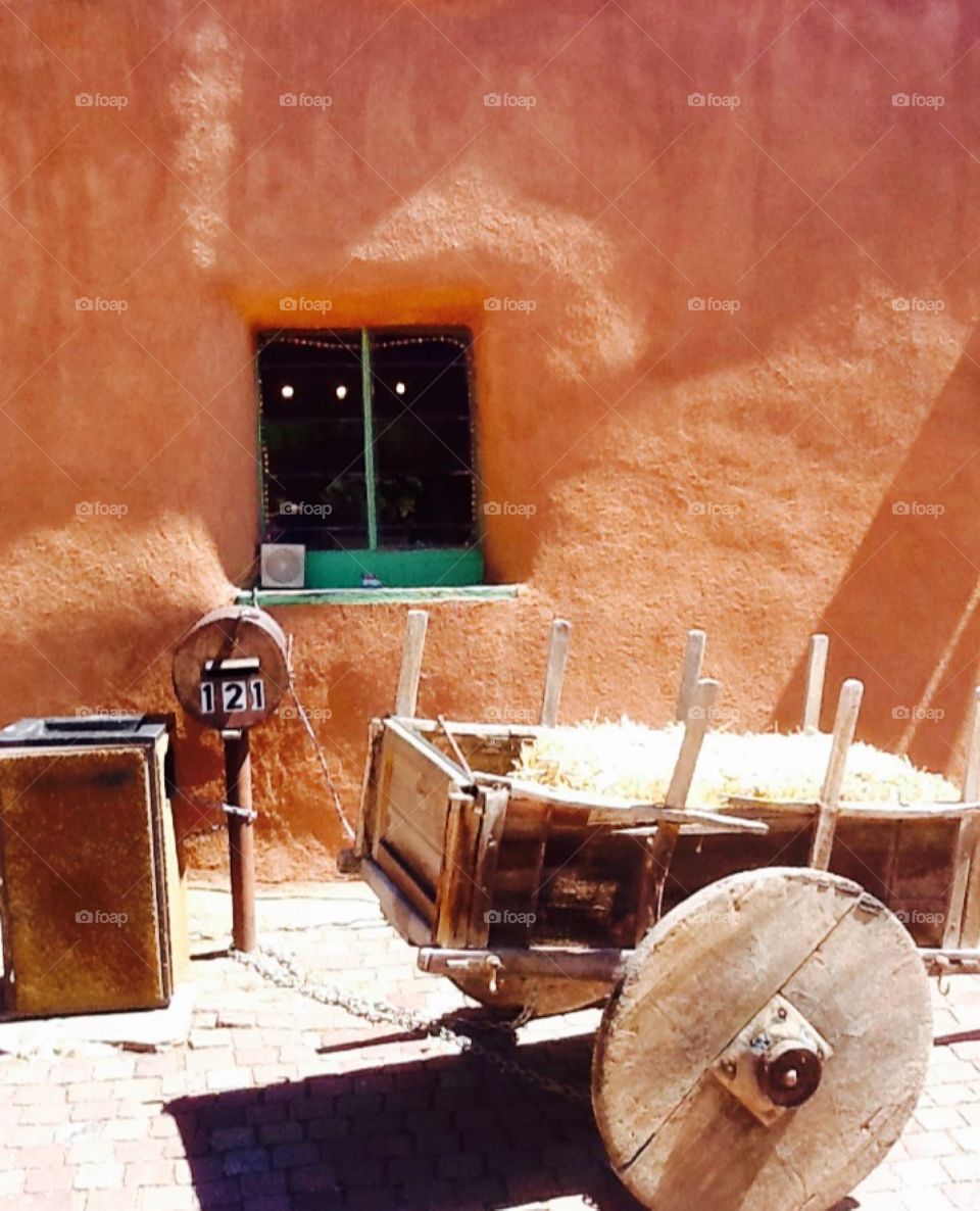 Wheel barrow outside of building in Taos, New Mexico