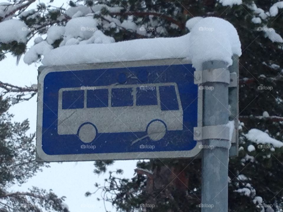 Bus stop sign, covered with snow in Finland