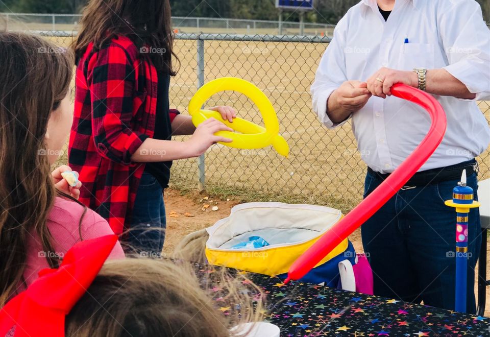 Magician making balloon animals 