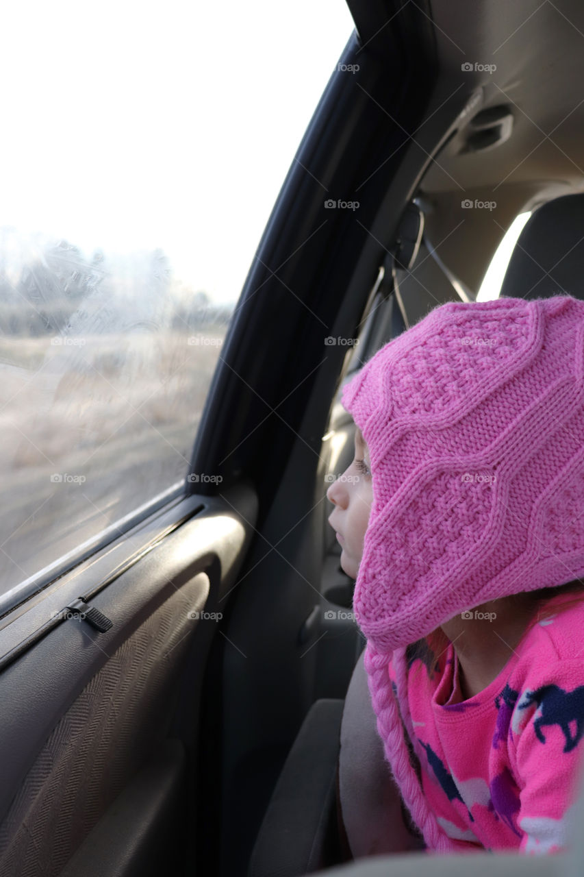 Child looking out a car window