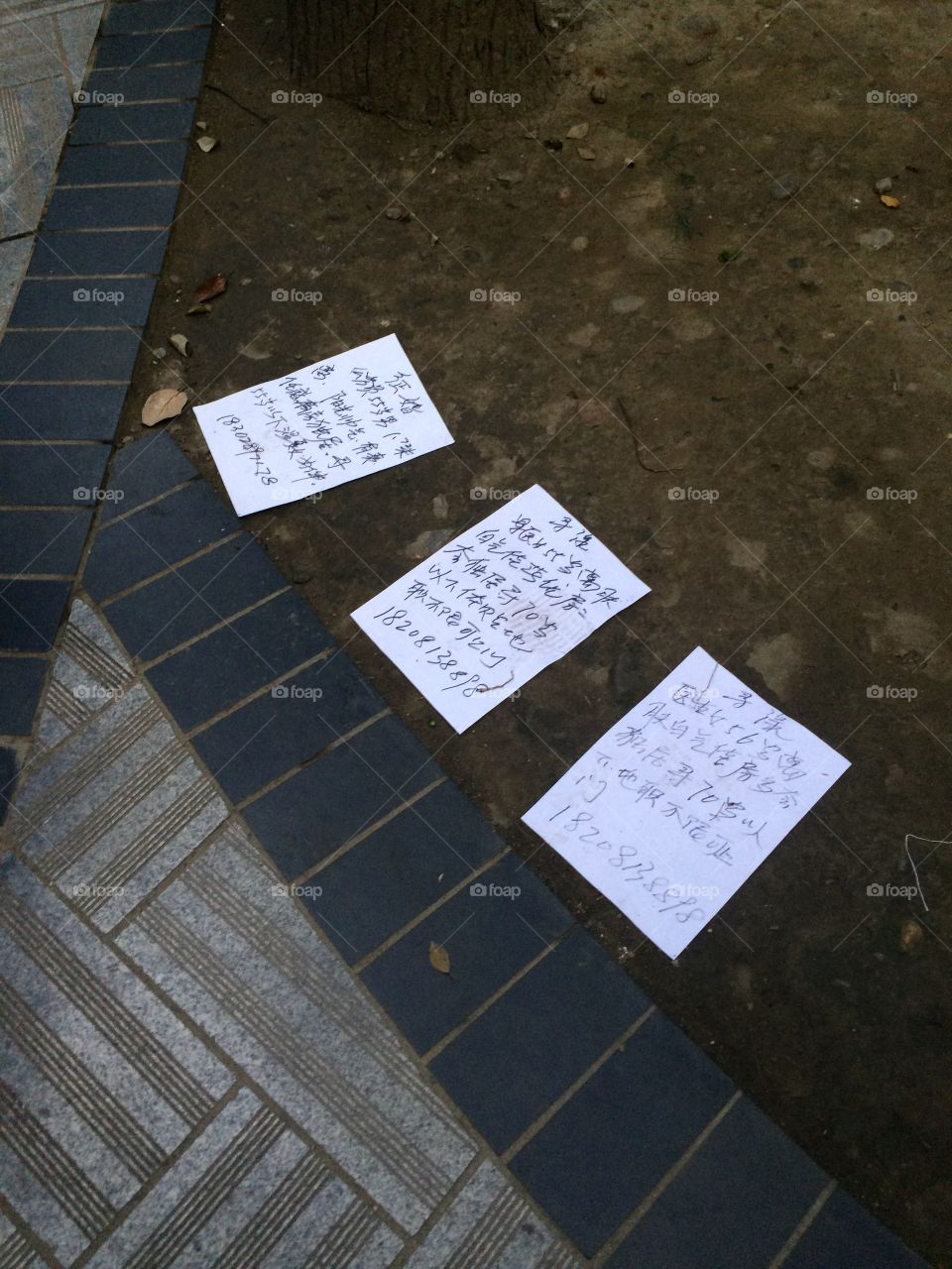 Personal ads on the ground in an Asian park