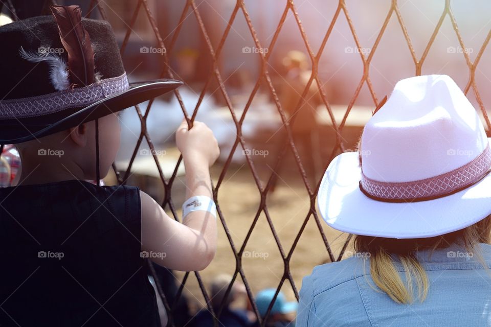 Siblings. Two children looking at a western show