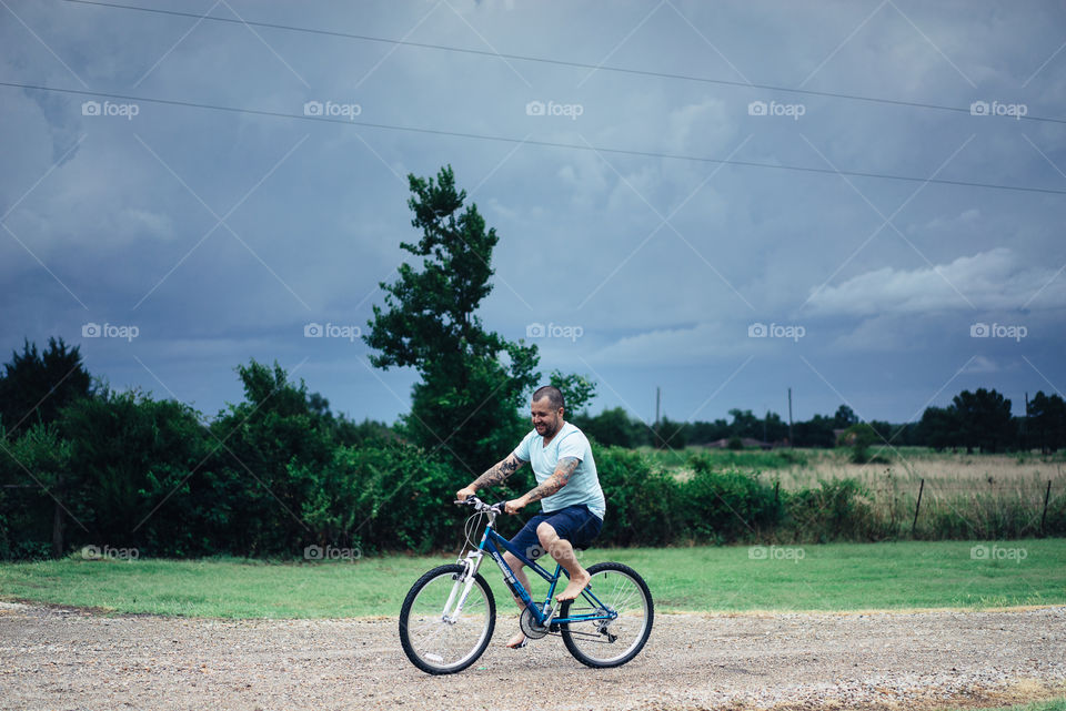 Smiling man cycling on road