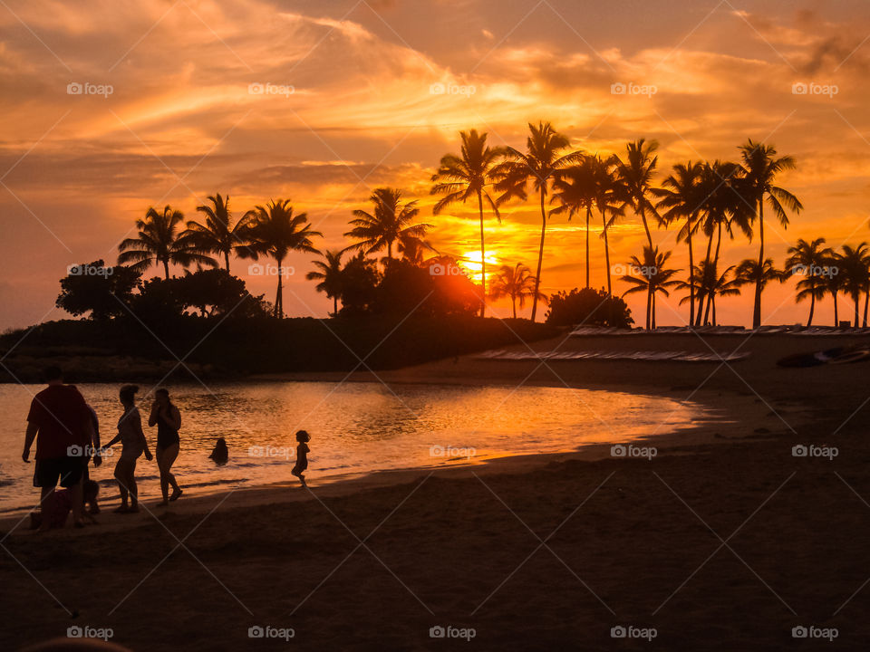 Hawaiian tropical sunset. Ko'olina beach lagoon sunset Hawaii Oahu island with family in the shoot