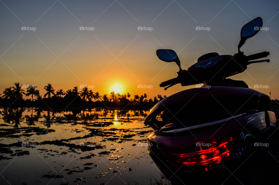 Motorcycle, Field and Sunset in Country, Thailand