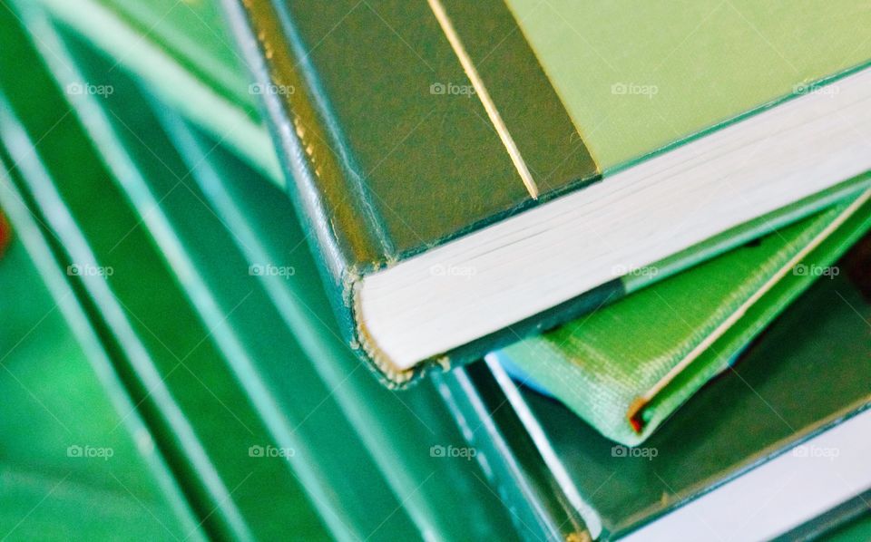 Green Color Story - stacked books with various shades of green covers 