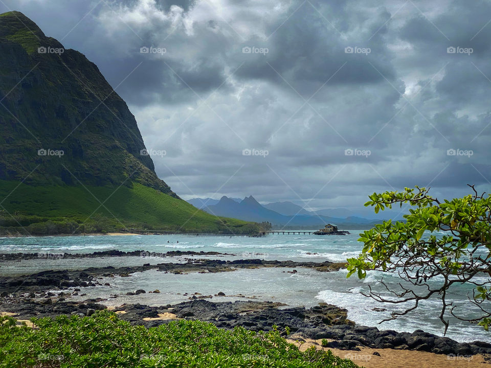 Hawaiian landscape with a house at the end of a pier