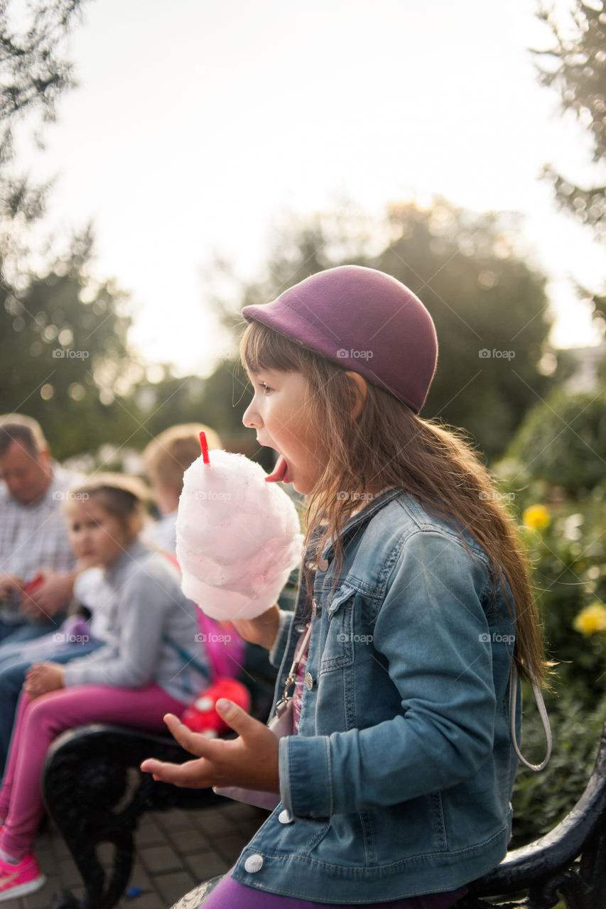 Little girl eating sugar outdoor