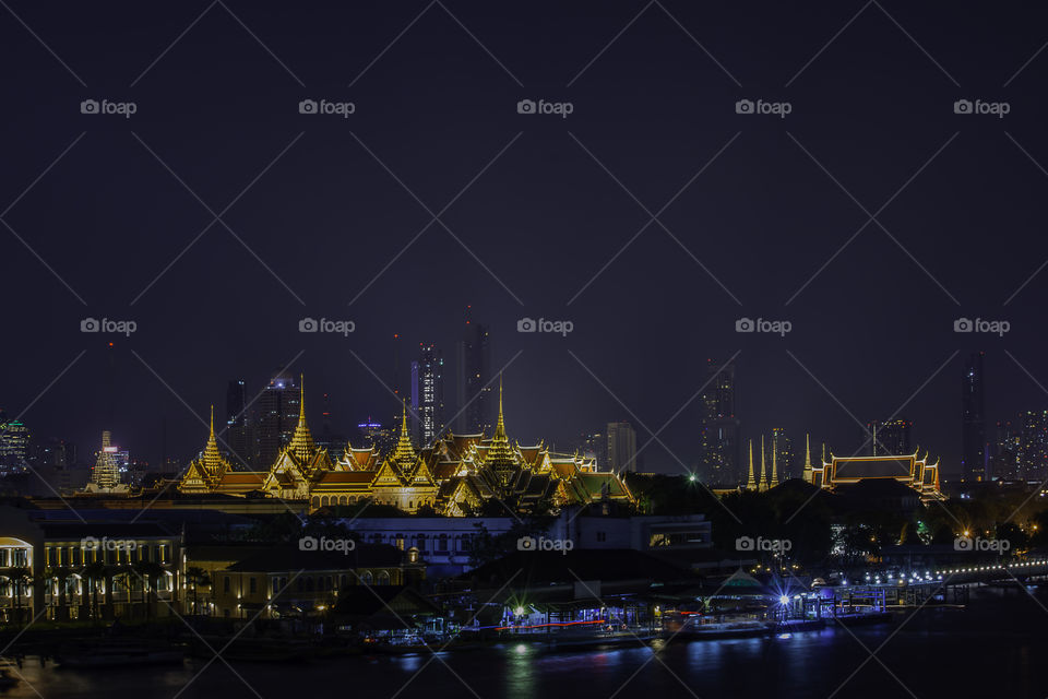 The beauty of the Golden palaces and phra keaw Temple ,The Chao Phraya River at night in Bangkok, Thailand.