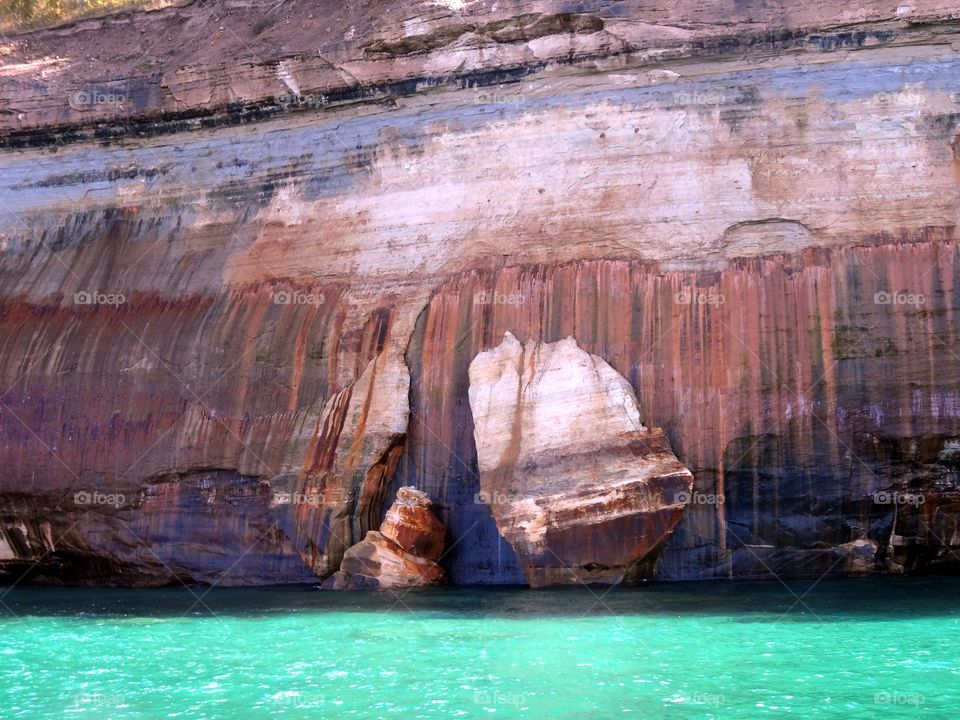 So beautiful it almost looks fake. Gorgeous scenery of rocks and crystal blue water.
