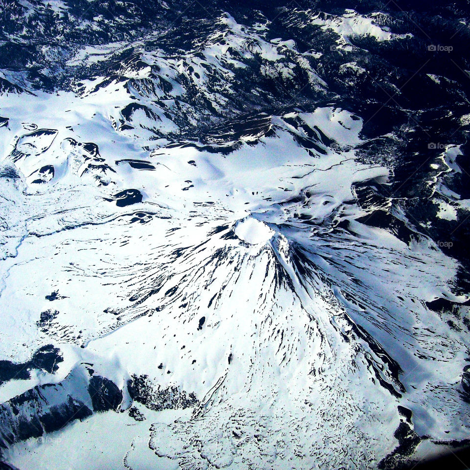 After Indonesia, Chile has the second largest and most active volcanic chain on Earth. [1] Along the continental Chilean territory, there are at least two thousand volcanoes; [1] [2] [3] of them , five hundred are considered "geologically active", [1] of which sixty have an historical eruptive record in the last 450 years, with a total of approximately three hundred eruptions in that period. [4] [n 1] the 200 historically active volcanoes of the Andes mountain range, 36 (18%) are in Chile. [6]

Of the Chilean volcanoes, forty-three are monitored by the National Volcanic Surveillance Network of the National Geology and Mining Service of Chile (Sernageomin). [7] According to a study by that agency, the ten most dangerous volcanoes in Chile are: [8] Villarrica, Llaima, Calbuco, Chaitén, Láscar, Michinmahuida, Nevados de Chillán, Lonquimay, Copahue and Azul-Quizapú. [9]