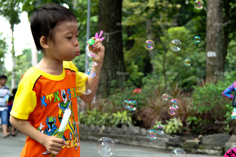 A boy playing bubbles