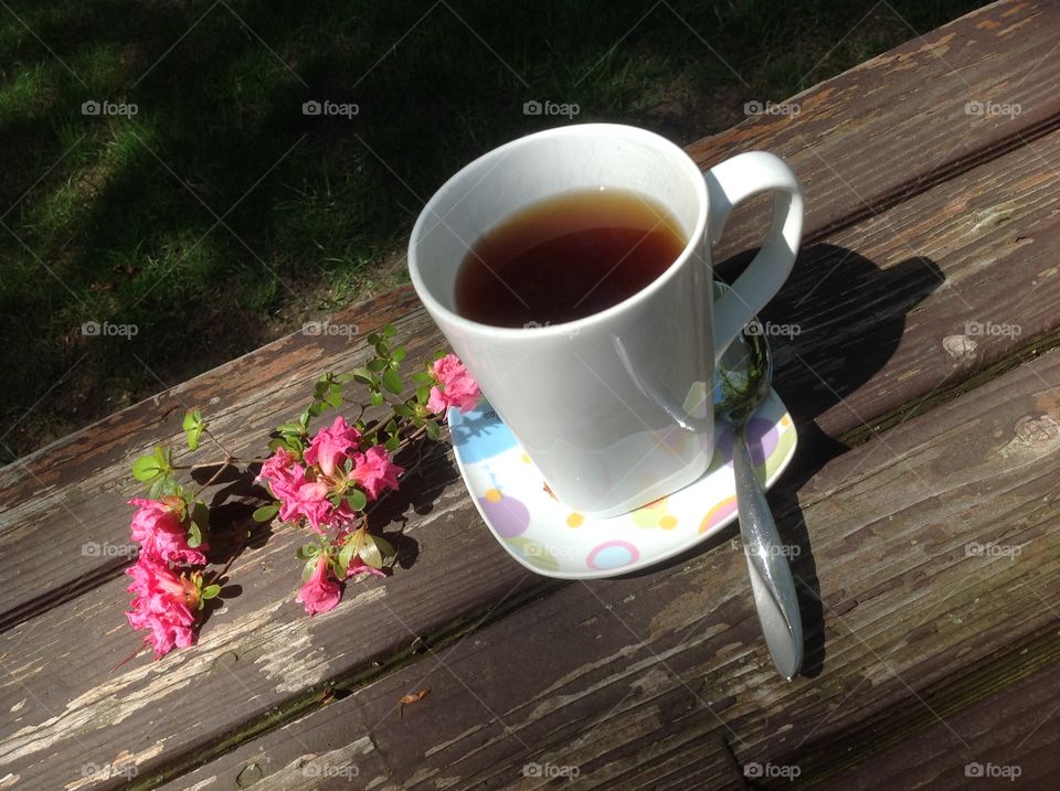 Enjoying a cup of coffee on a beautiful spring day outdoors.