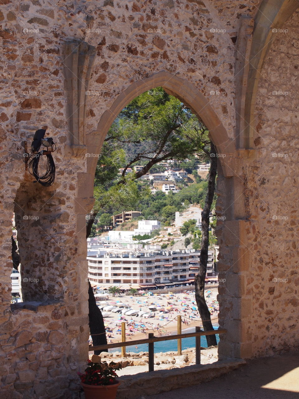 view of the beach in ruined church window