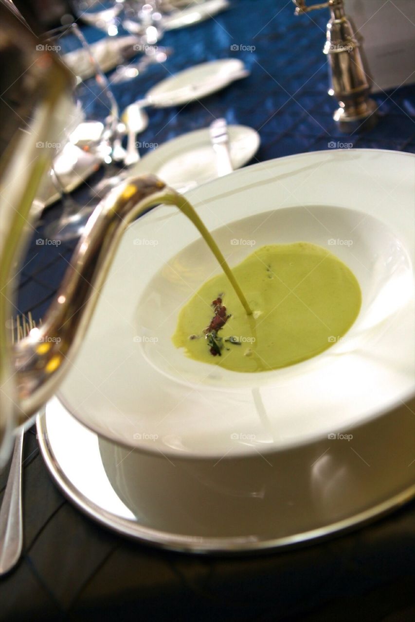 Serving broccoli creme soup on a fancy gathering