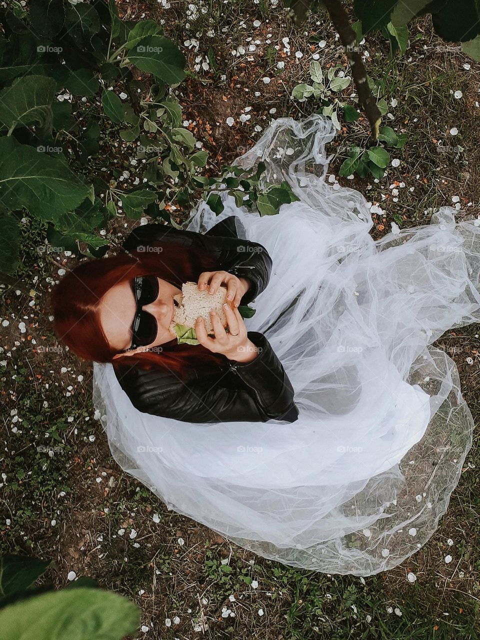 A picnic for one under a flowering tree in a city park